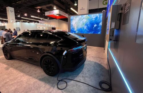 GoodWe/GE’s inverter-integrated charger is plugged into a Tesla at RE+ 2022.